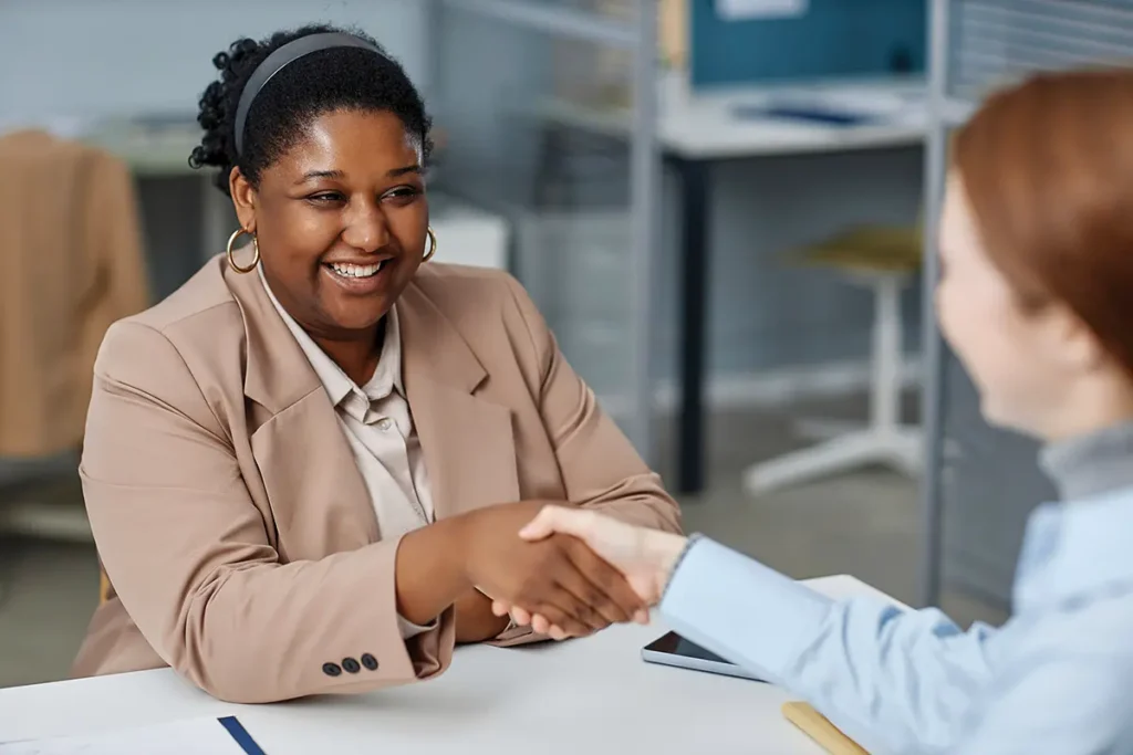 Two professional women shaking hands