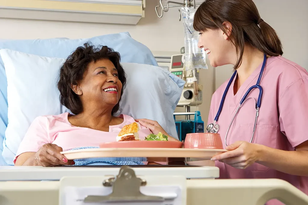 Older woman being served hospital food